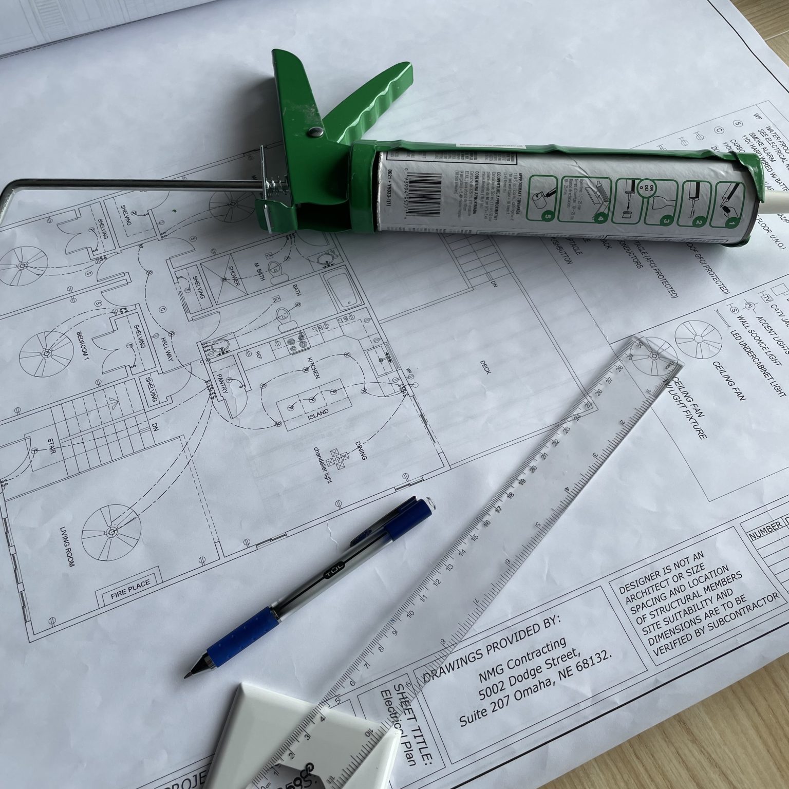 NMG Contracting photo in meeting room with drawings designed by our company.