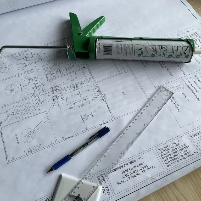 NMG Contracting photo in meeting room with drawings designed by our company.